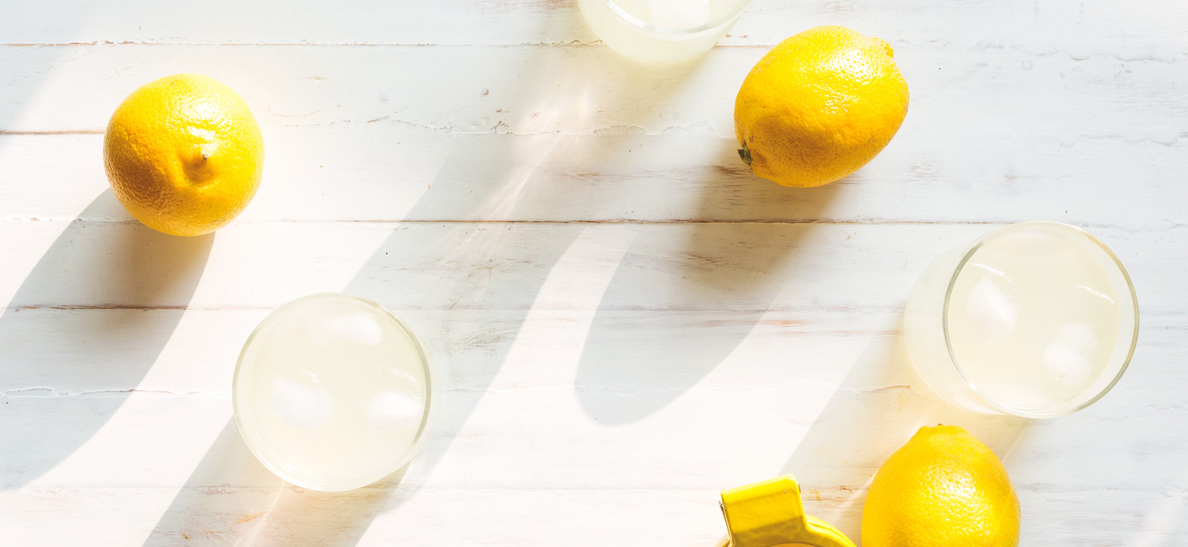 lemonade-on-white-woodgrain-table_f5357faa-4000-4a24-be8e-896086e7b427.jpg